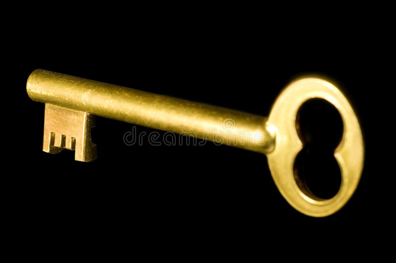 A shiny old-style golden key isolated on black background. A shiny old-style golden key isolated on black background.