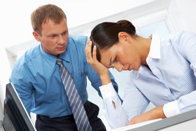 Portrait of young employee having trouble or headache with her boss at background. Portrait of young employee having trouble or headache with her boss at background