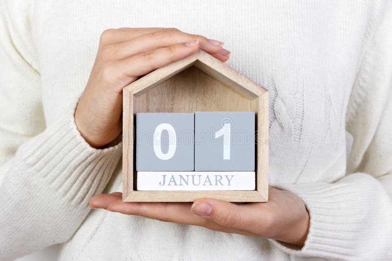 January 1 in the calendar. the girl is holding a wooden calendar. New Year. World Day of Peace. Feast of Mary. January 1 in the calendar. the girl is holding a wooden calendar. New Year. World Day of Peace. Feast of Mary.