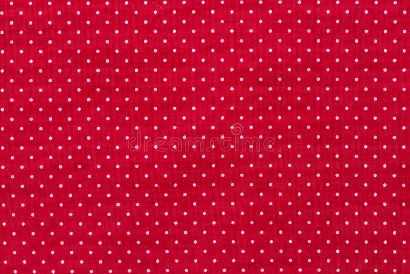 Às bolinhas na textura vermelha do algodão da lona, fundo da tela foto de stock Às bolinhas na textura vermelha do algodão da lona, fundo da tela foto de stock