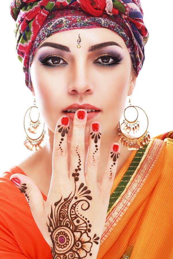 Beautiful woman arabian make up and turban on head with detail of henna being applied to hand and backt isolated. Beautiful woman arabian make up and turban on head with detail of henna being applied to hand and backt isolated