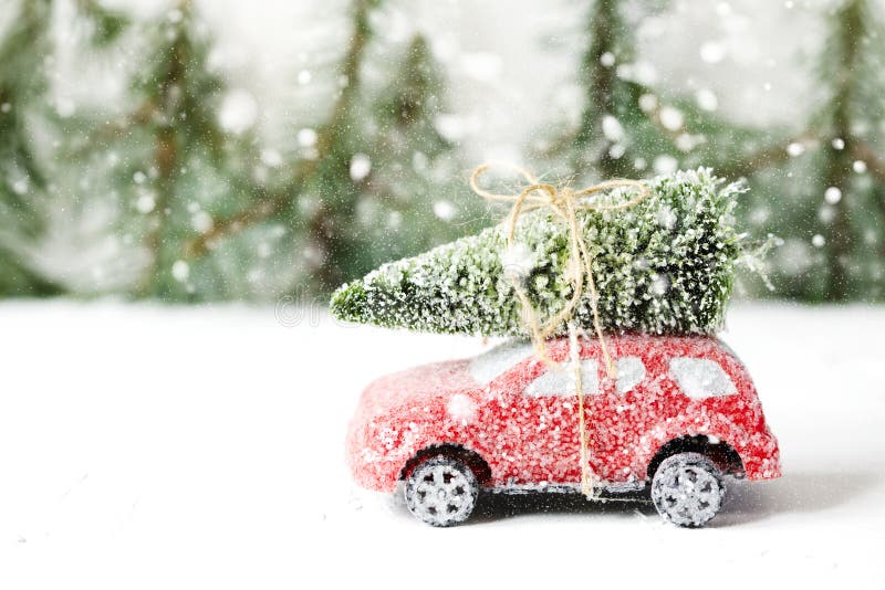 Christmas tree on red car toy with snow. Winter holiday celebration and Happy new year concept, copy space. Christmas tree on red car toy with snow. Winter holiday celebration and Happy new year concept, copy space