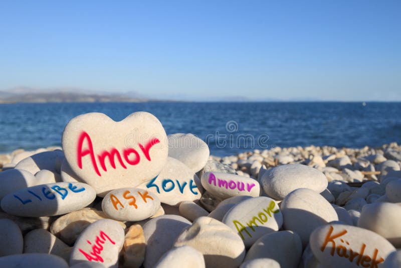 â€œLoveâ€ written in different languages, on the beach. â€œLoveâ€ written in different languages, on the beach