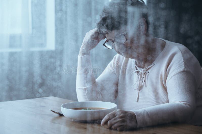 Photo through window with elderly woman with eating disorders in background. Photo through window with elderly woman with eating disorders in background