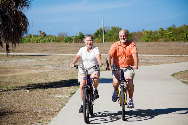 Happy active senior couple riding their bicycles. Happy active senior couple riding their bicycles.