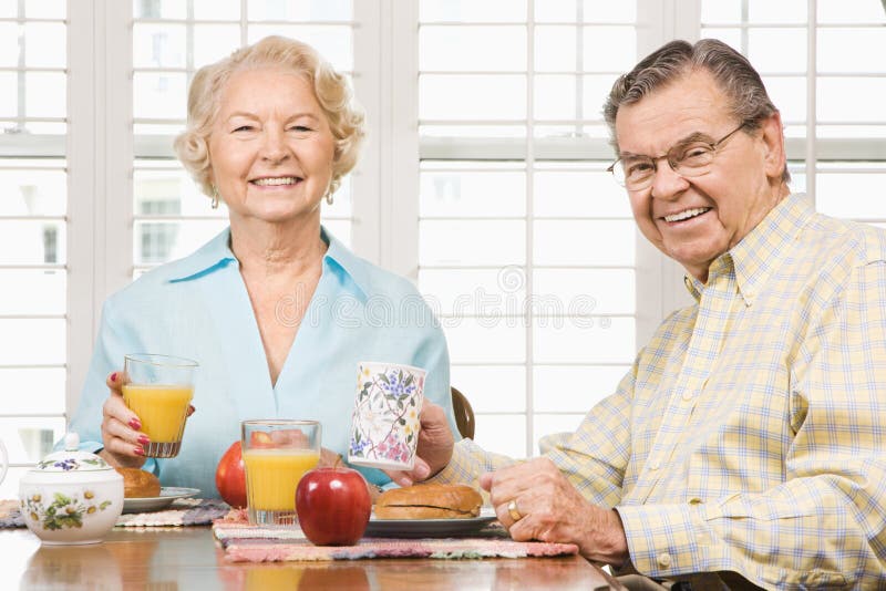 Mature Caucasian couple having breakfast together. Mature Caucasian couple having breakfast together.