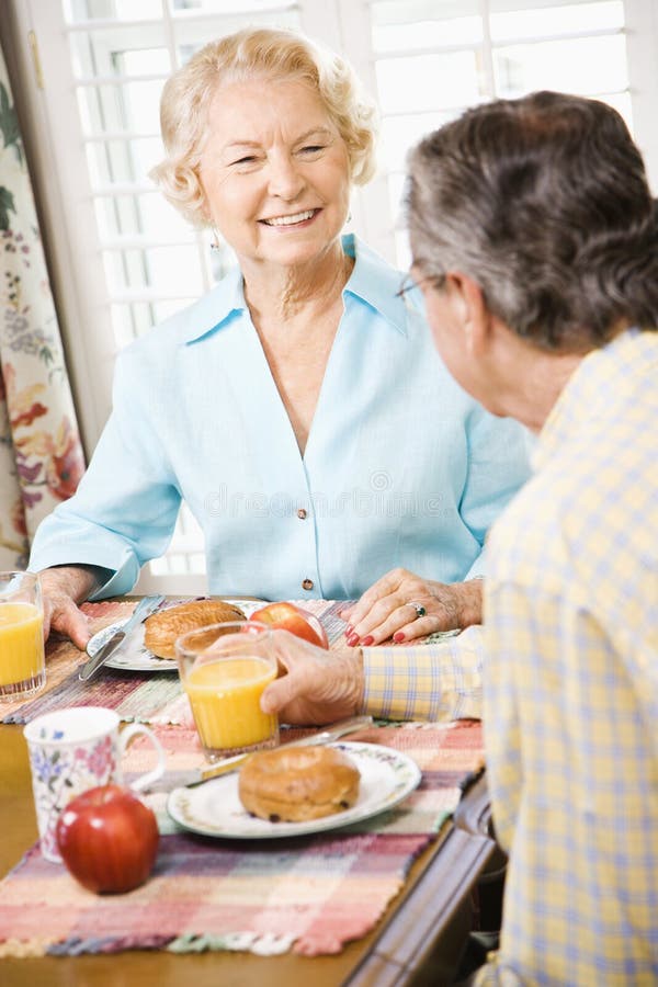 Mature Caucasian couple having breakfast together. Mature Caucasian couple having breakfast together.