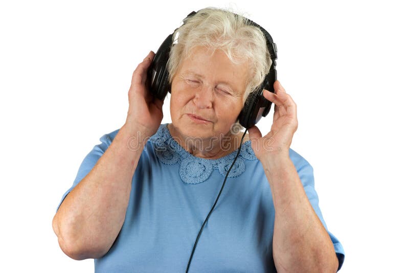 Senior woman is enjoying music with earphones. Senior woman is enjoying music with earphones