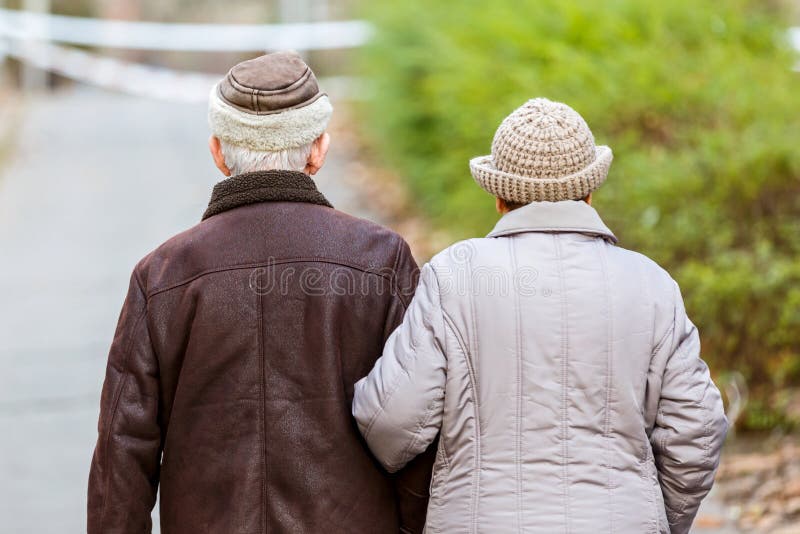 Photo of elderly couple walking in the park. Photo of elderly couple walking in the park