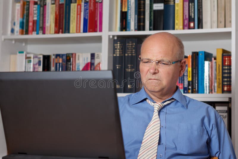 Älterer Mann angewidert mit Computer lizenzfreie stockfotografie Älterer Mann angewidert mit Computer lizenzfreie stockfotografie