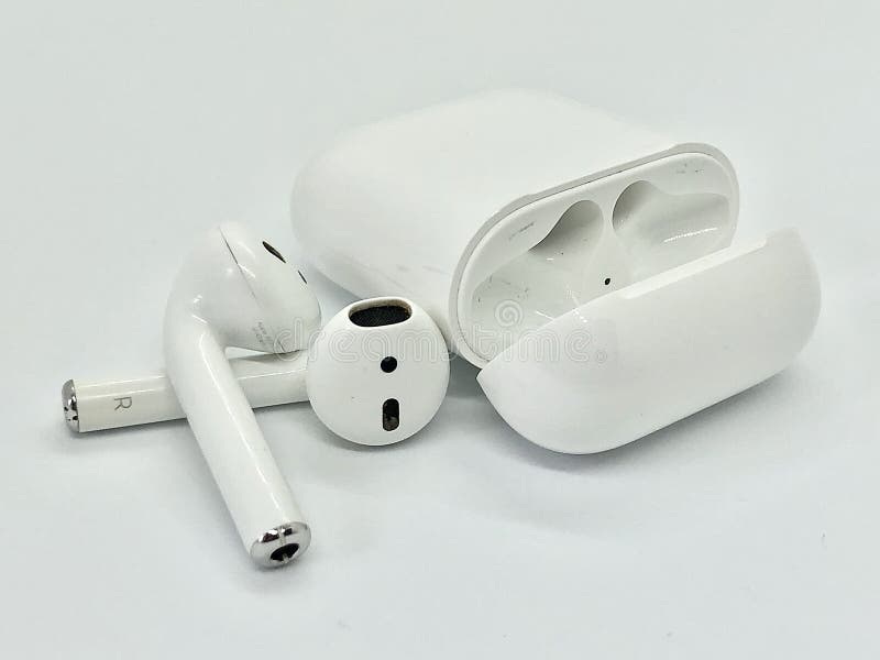 Apple AirPods, white wireless ear buds with charging case on the white background. Apple AirPods, white wireless ear buds with charging case on the white background.