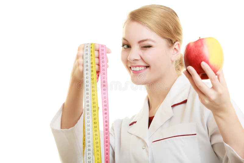 Äpple för frukt för doktorsspecialistinnehav och måttband arkivfoton Äpple för frukt för doktorsspecialistinnehav och måttband arkivfoton