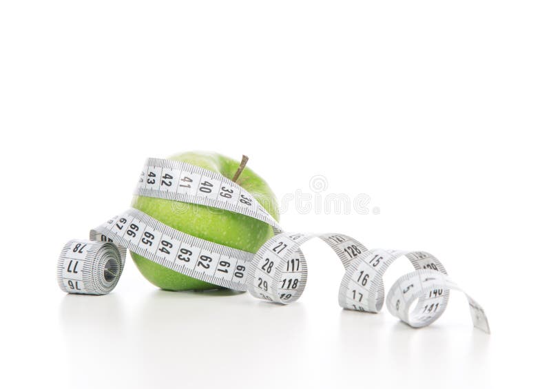 Healthy diet weight loss concept green apple and tape measure on a white background. Healthy diet weight loss concept green apple and tape measure on a white background