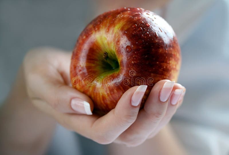 Apple in a female hand, closeup. Apple in a female hand, closeup