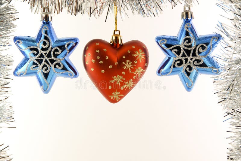 Celebratory New Year's ornaments on a tinsel photographed on a white background. Celebratory New Year's ornaments on a tinsel photographed on a white background