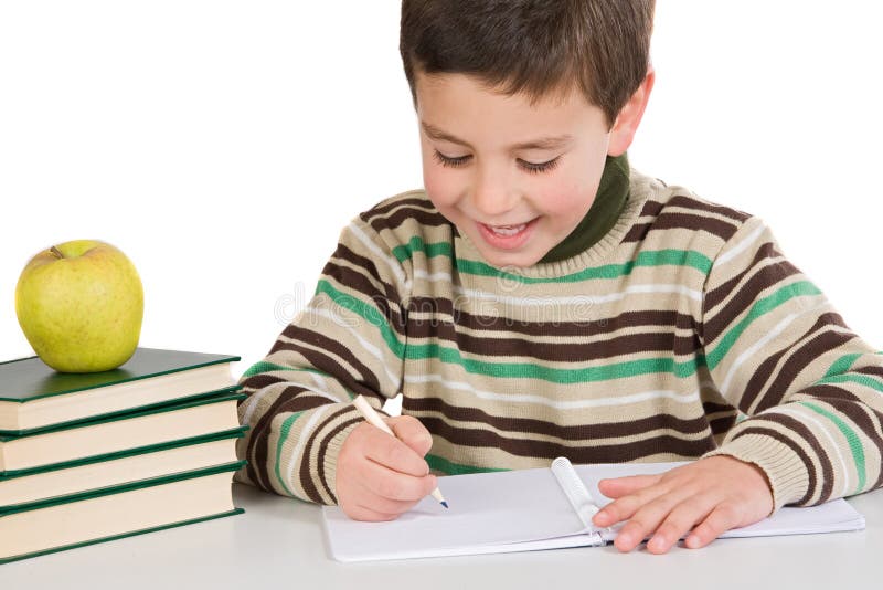 Écriture adorable d'enfant dans l'école photo stock Écriture adorable d'enfant dans l'école photo stock