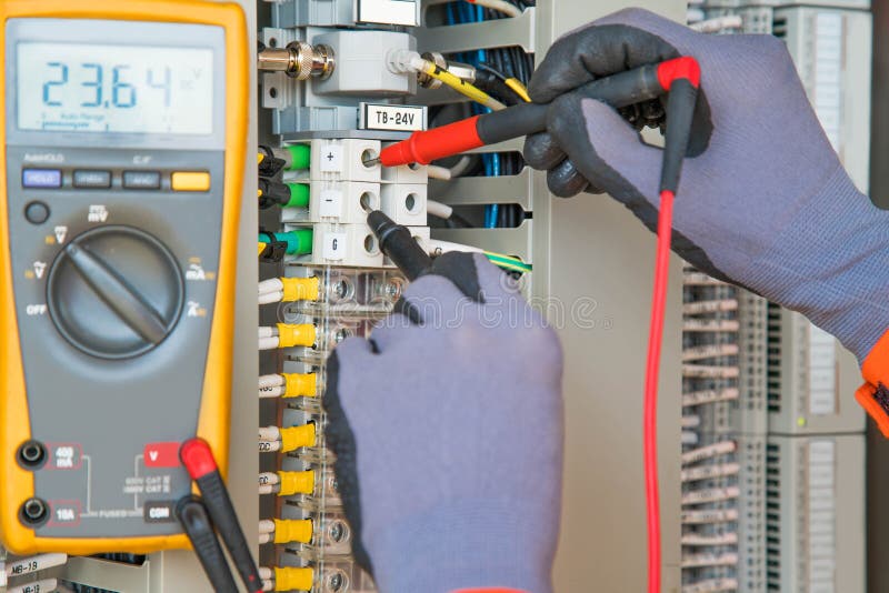 Électricien et travailleur d'instruments portant des gants de sécurité mesurant la tension et vérifiant le circuit électrique photo libre de droits Électricien et travailleur d'instruments portant des gants de sécurité mesurant la tension et vérifiant le circuit électrique photo libre de droits