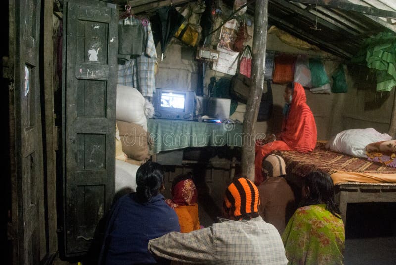 A group of village people are watching Television inside a lighted room at Sunderban, West Bengal, India. Sunderban Rural Energy Project aims to disseminate solar and other renewable energy to people located in Sunderban area who were earlier using kerosene. The project benefits about 3 lakh people through improved power supply and provides employment to around 400 in on site business. The project is innovative as it provides off grid but grid quality powered energy system. The new approach is the use of solar photo voltaic and hybrid wind, locally fed with solar energy. The system is owned and managed by the people who also collect revenue for the electricity services provided to houses. A group of village people are watching Television inside a lighted room at Sunderban, West Bengal, India. Sunderban Rural Energy Project aims to disseminate solar and other renewable energy to people located in Sunderban area who were earlier using kerosene. The project benefits about 3 lakh people through improved power supply and provides employment to around 400 in on site business. The project is innovative as it provides off grid but grid quality powered energy system. The new approach is the use of solar photo voltaic and hybrid wind, locally fed with solar energy. The system is owned and managed by the people who also collect revenue for the electricity services provided to houses.