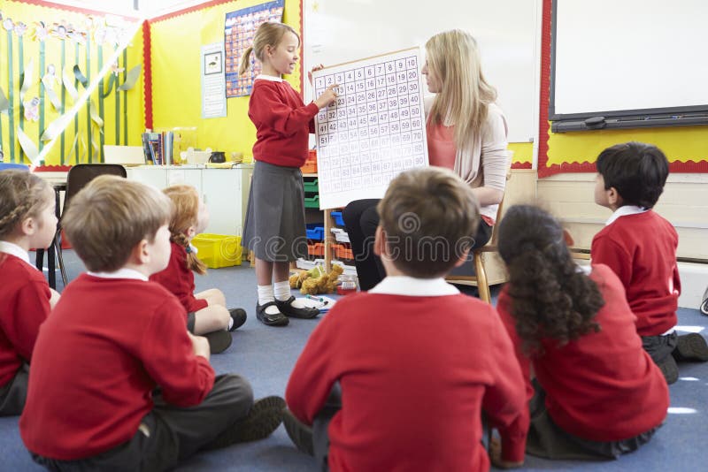 Élèves d'école primaire de Teaching Maths To de professeur photographie stock libre de droits Élèves d'école primaire de Teaching Maths To de professeur photographie stock libre de droits