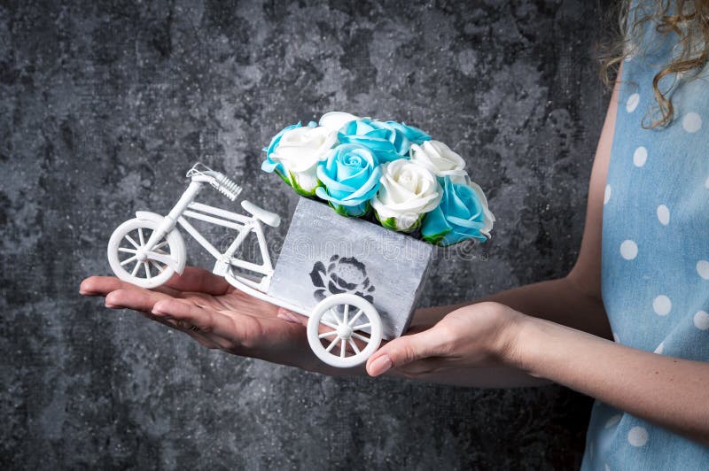 Épouser le décor fait main : La fille tient un petit bouquet des roses dans des ses mains dans une boîte décorative sous forme d' photo stock Épouser le décor fait main : La fille tient un petit bouquet des roses dans des ses mains dans une boîte décorative sous forme d' photo stock