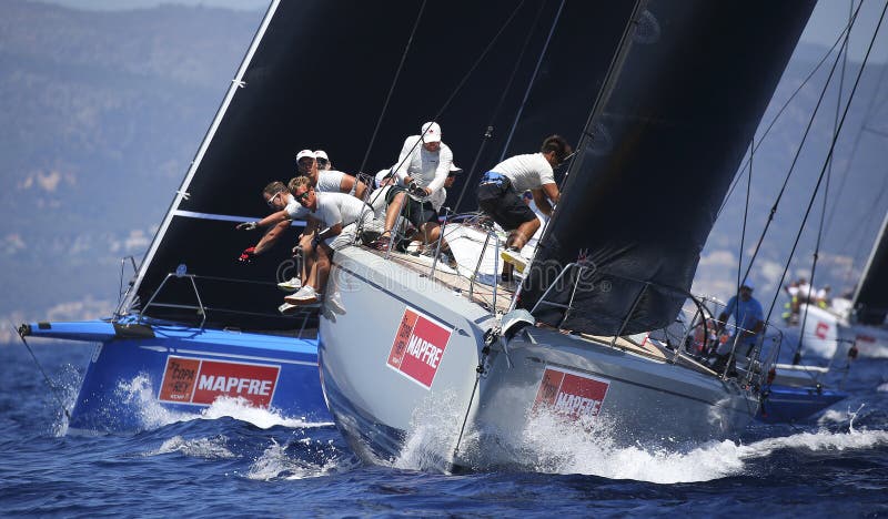 The crew of a swan 50 class ship at work during the kings cup sailing regatta in the island of Mallorca. The crew of a swan 50 class ship at work during the kings cup sailing regatta in the island of Mallorca