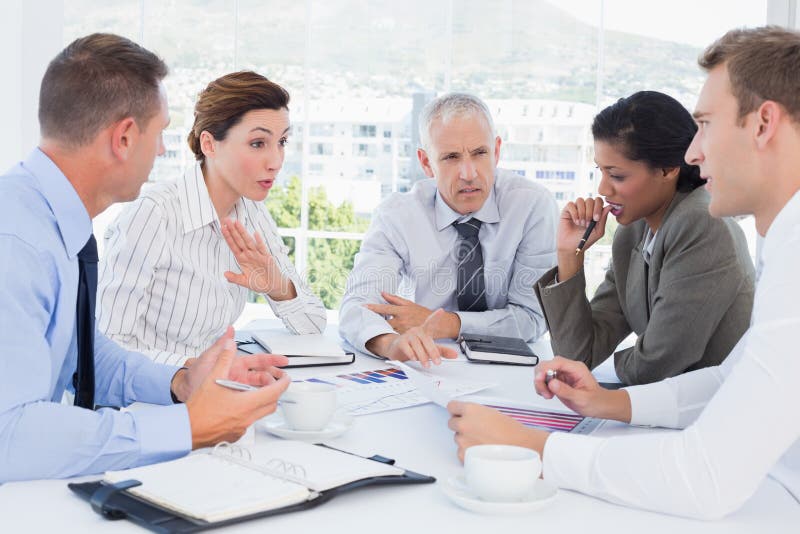 Business team analyzing the graphs in the office. Business team analyzing the graphs in the office