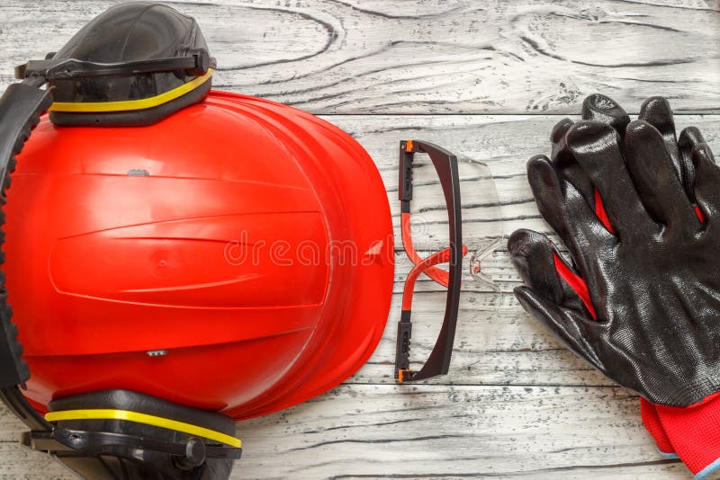 Personal protective equipment: black gloves goggles glasses on a wooden background. Personal protective equipment: black gloves goggles glasses on a wooden background.