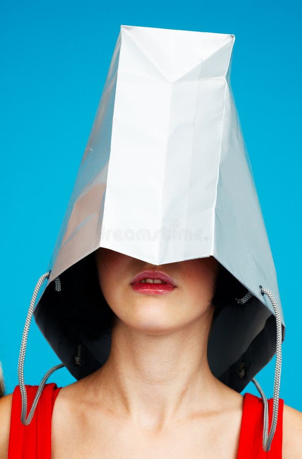 Teen wears a shopping bag as hat ready to shop. Teen wears a shopping bag as hat ready to shop.