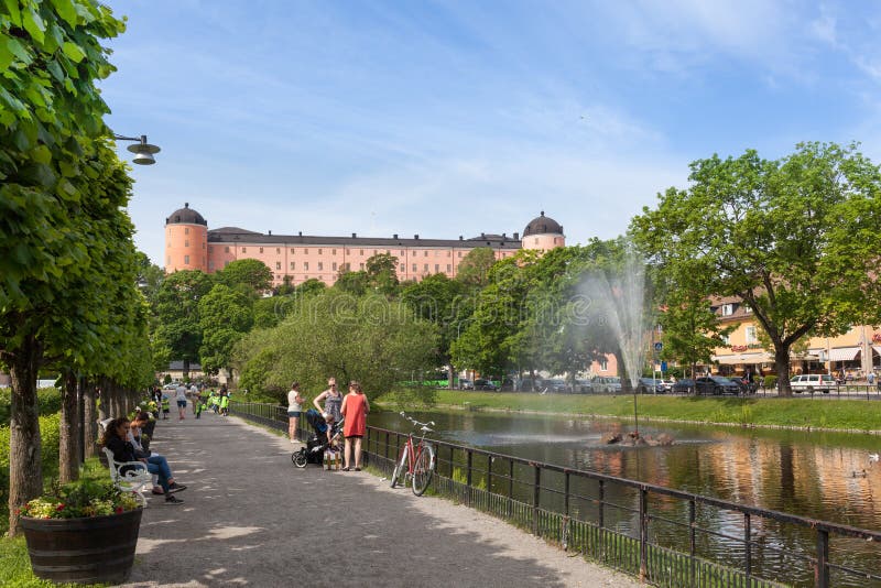 Uppsala, Sweden - Jun 1, 2016 : Swan pond against the Uppsala Castle. This pond was built in 1500s and one of the most popular promenades in the center of Uppsala City. Uppsala, Sweden - Jun 1, 2016 : Swan pond against the Uppsala Castle. This pond was built in 1500s and one of the most popular promenades in the center of Uppsala City.