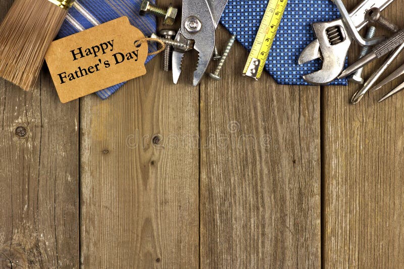 Happy Fathers Day gift tag with top border of tools and ties on a rustic wood background. Happy Fathers Day gift tag with top border of tools and ties on a rustic wood background