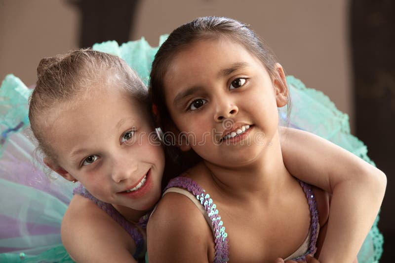 Young ballet student gives her friend a hug. Young ballet student gives her friend a hug