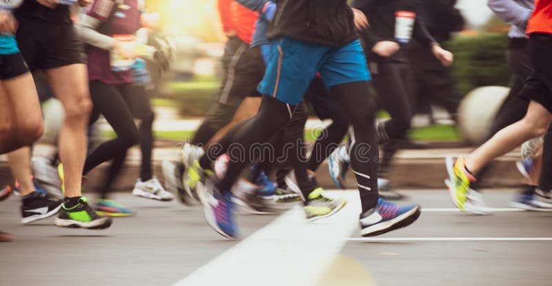 Étroitement de la course de marathon courante des pieds des personnes sur City Road Tache floue de mouvement photos libres de droits Étroitement de la course de marathon courante des pieds des personnes sur City Road Tache floue de mouvement photos libres de droits