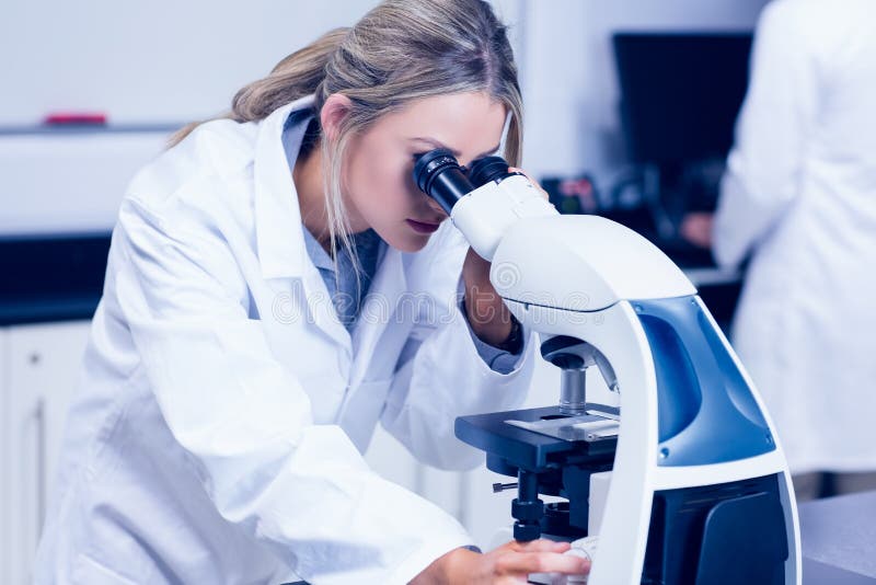 Étudiant de la Science regardant par le microscope dans le laboratoire images libres de droits Étudiant de la Science regardant par le microscope dans le laboratoire images libres de droits