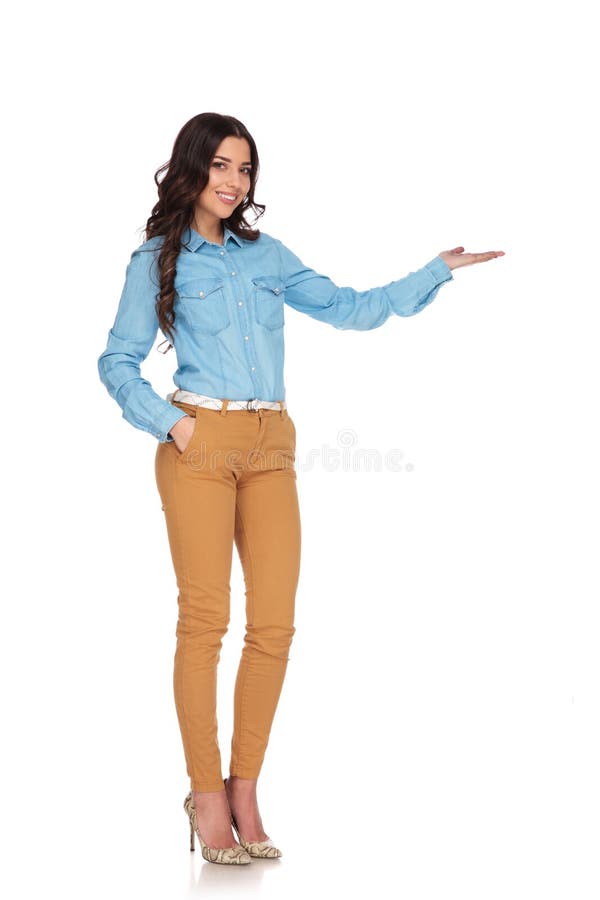 Étudiant de sourire de jeune femme présent avec sa paume au côté image libre de droits Étudiant de sourire de jeune femme présent avec sa paume au côté image libre de droits