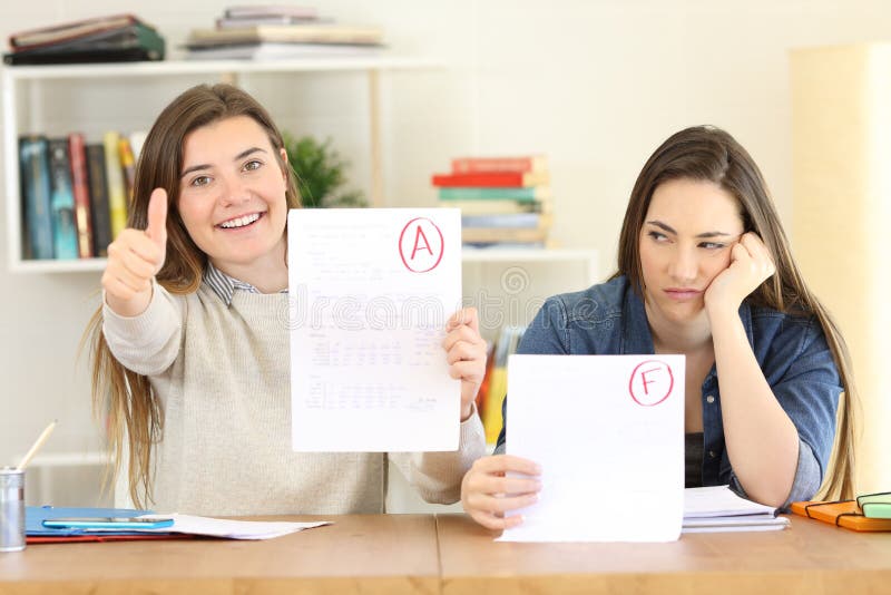 Front view portrait of two students showing failed and approved exams at home. Front view portrait of two students showing failed and approved exams at home