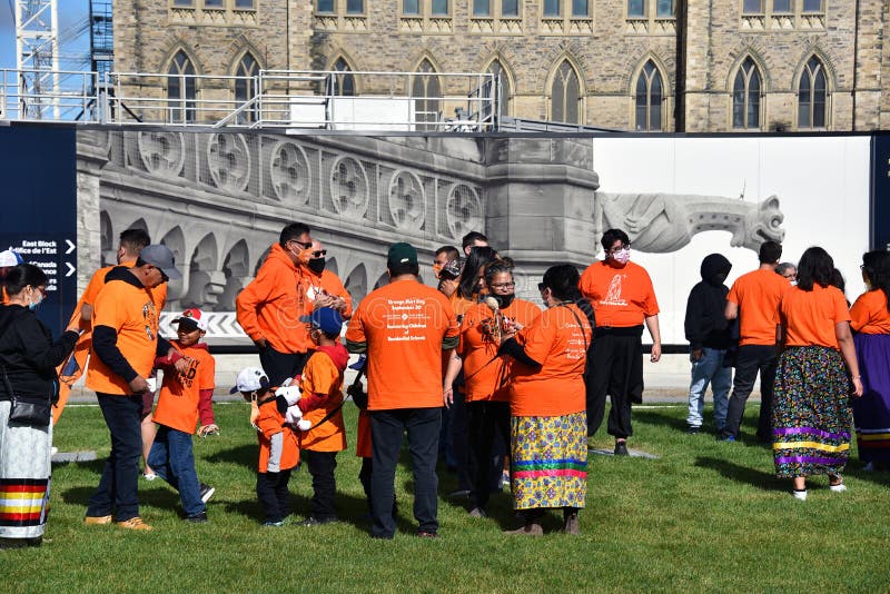 Ottawa, Canada - September 30, 2021: A crowd gathers on Parliament Hill for event on The National Day for Truth and Reconciliation, aka Orange Shirt Day. The day was proclaimed to be a statutory holiday by the Canadian government for the first time in 2021 in light of the revelations of over 1,000 unmarked graves near former residential school sites. Ottawa, Canada - September 30, 2021: A crowd gathers on Parliament Hill for event on The National Day for Truth and Reconciliation, aka Orange Shirt Day. The day was proclaimed to be a statutory holiday by the Canadian government for the first time in 2021 in light of the revelations of over 1,000 unmarked graves near former residential school sites