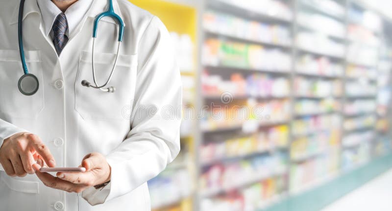 Αρσενικός φαρμακοποιός που χρησιμοποιεί το κινητό τηλέφωνο στο φαρμακείο στοκ εικόνες με δικαίωμα ελεύθερης χρήσης Αρσενικός φαρμακοποιός που χρησιμοποιεί το κινητό τηλέφωνο στο φαρμακείο στοκ εικόνες με δικαίωμα ελεύθερης χρήσης