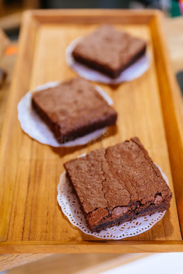 Τετραγωνικά Brownie κέικ σοκολάτας στον ξύλινο δίσκο που έτοιμο να πωλήσει Λειωμένο μέταλλο στο στόμα σας στοκ φωτογραφίες Τετραγωνικά Brownie κέικ σοκολάτας στον ξύλινο δίσκο που έτοιμο να πωλήσει Λειωμένο μέταλλο στο στόμα σας στοκ φωτογραφίες
