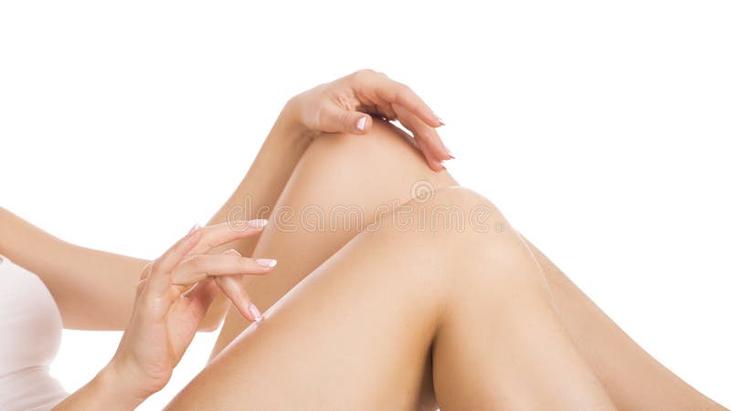 Молодая женщина касаясь шелковистой коже на ногах после epilation, изолированного на белой предпосылке ckin заботит концепция стоковое фото rf Молодая женщина касаясь шелковистой коже на ногах после epilation, изолированного на белой предпосылке ckin заботит концепция стоковое фото rf