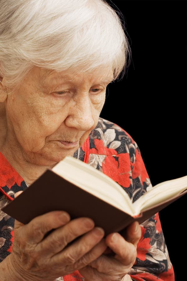 оld senior woman reads the book