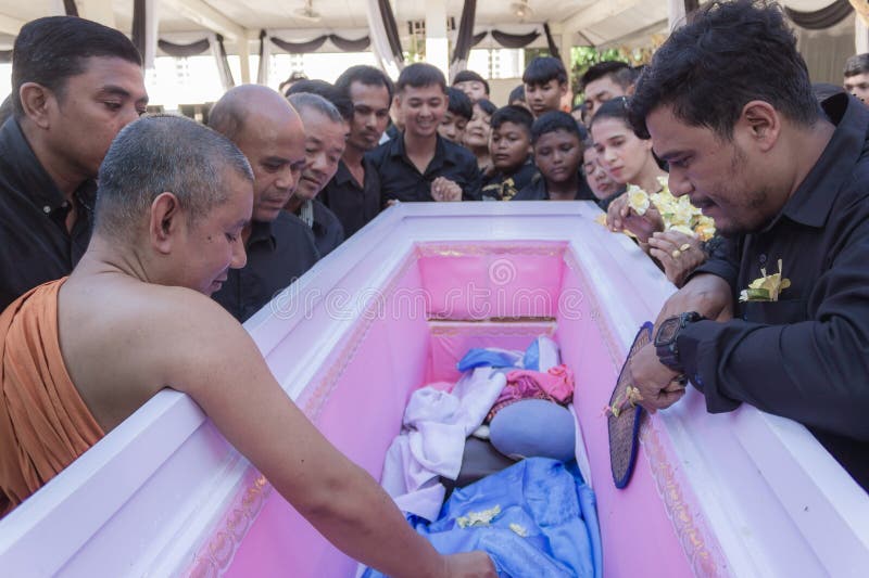 Phatthalung, Thailand- April 05, 2024: Opening the coffin of a dead person to give relatives a final look before putting it in the crematorium. Phatthalung, Thailand- April 05, 2024: Opening the coffin of a dead person to give relatives a final look before putting it in the crematorium