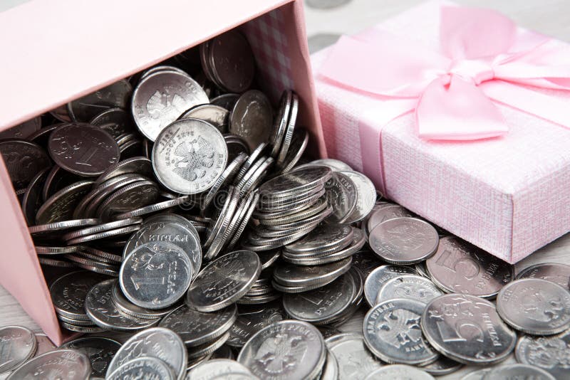 Open pink gift box with russian ruble coins close up. Open pink gift box with russian ruble coins close up