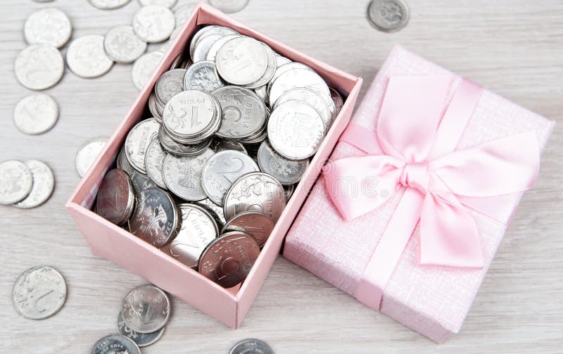 Open pink gift box with russian ruble coins top view. Open pink gift box with russian ruble coins top view