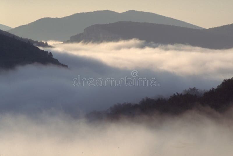Mountains above the clouds. Film grain is visible. Mountains above the clouds. Film grain is visible.
