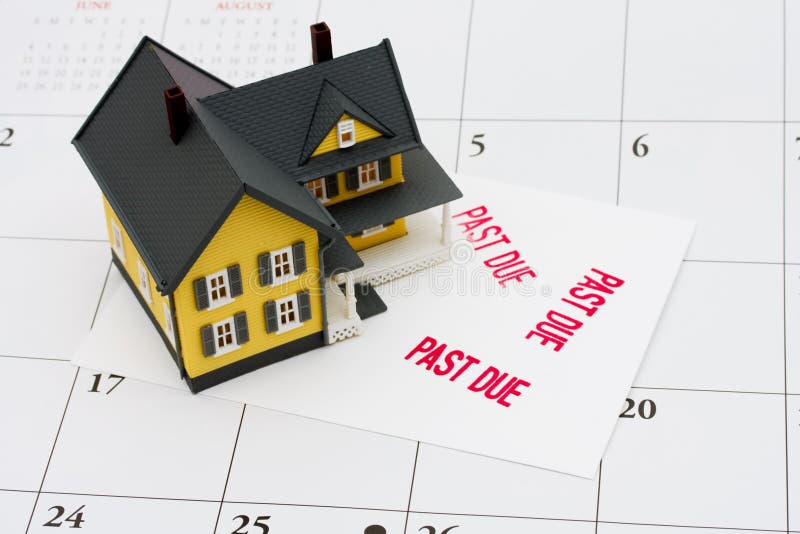 An overdue bill beside a house on calendar background, overdue mortgage. An overdue bill beside a house on calendar background, overdue mortgage