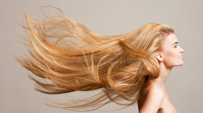 Portrait of a beautiful young blond woman with amazing flowing hair. Portrait of a beautiful young blond woman with amazing flowing hair.