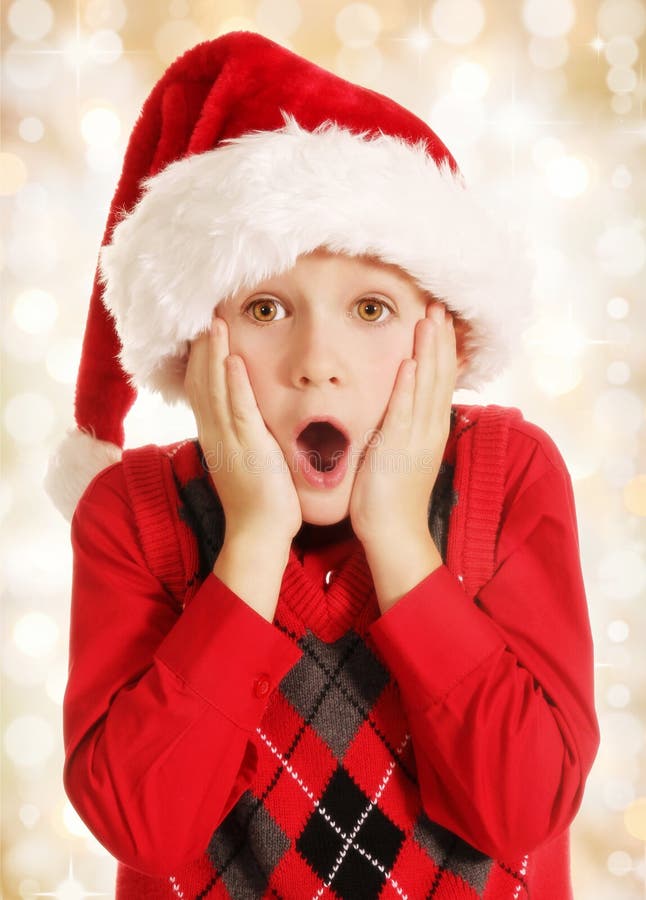 Überraschter Weihnachtsjunge lizenzfreies stockfoto Überraschter Weihnachtsjunge lizenzfreies stockfoto