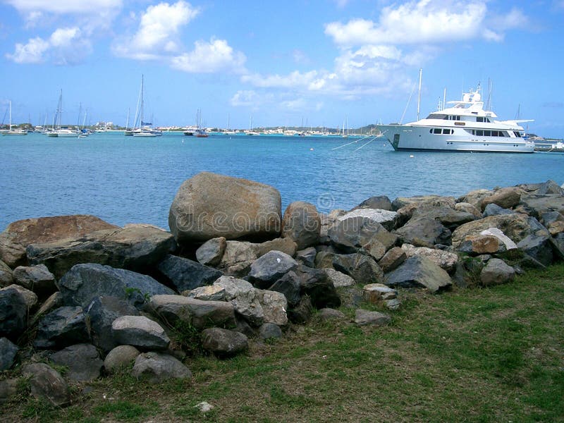 An anchored boat in a harbor at St. Maarten, Caribbean. An anchored boat in a harbor at St. Maarten, Caribbean.