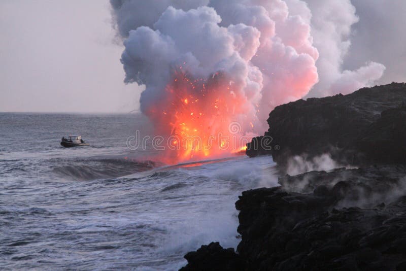 Big Island volcano's lava flowing into ocean and a boat wathing up close. Big Island volcano's lava flowing into ocean and a boat wathing up close