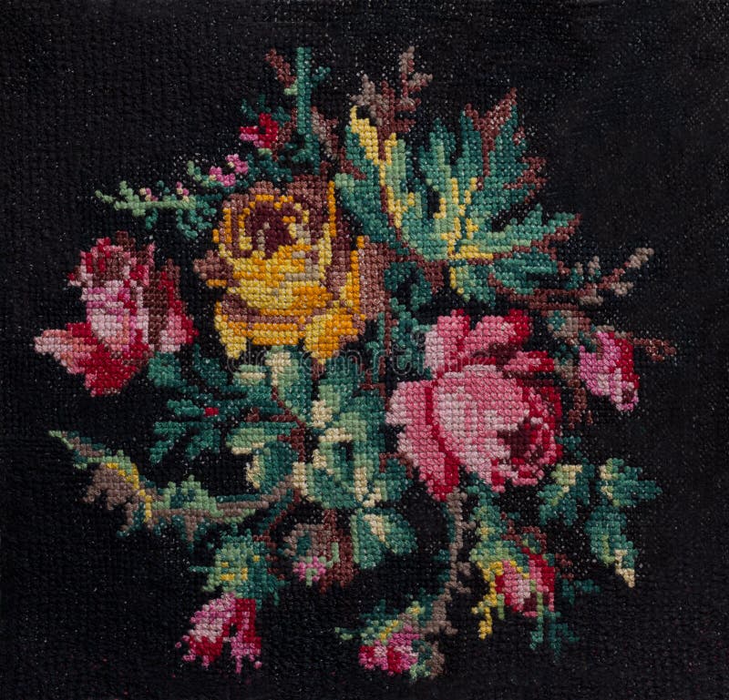 Cross-stitch handmade embroidery. The bouquet of roses and leafs on black background. Decorative element for design. Cross-stitch handmade embroidery. The bouquet of roses and leafs on black background. Decorative element for design.